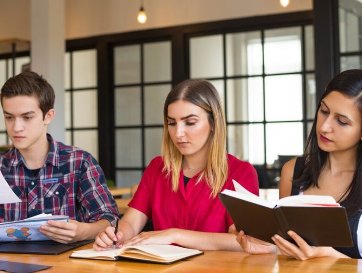 portrait-three-serious-students-studying-library_1262-18011